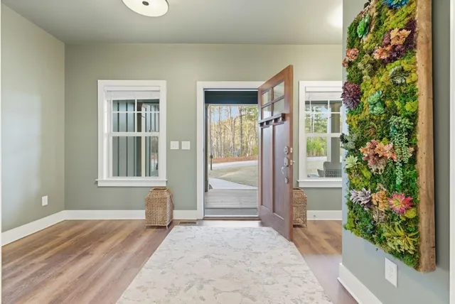 a view of porch with a floor to ceiling window and potted plants