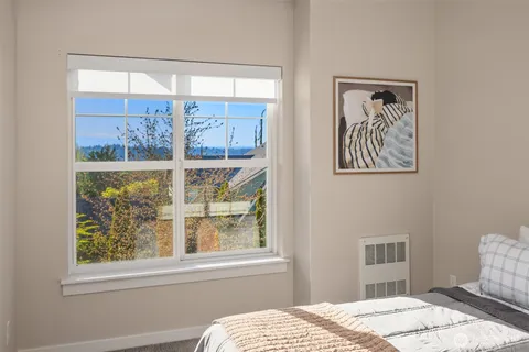 a bedroom with a bed and a window