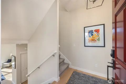 a view of hallway with a large window and a bathroom