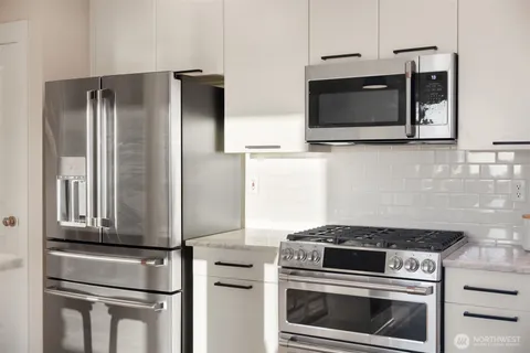 a kitchen with stainless steel appliances wooden cabinets and stove