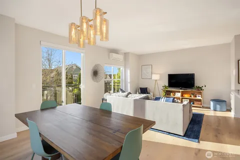 a living room with furniture wooden floor and a flat screen tv