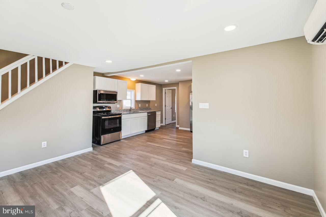 4912 Ocean Gateway Vienna, MD 21869 - Photo 11 of 35 a view of a kitchen with a sink stove cabinets and empty room