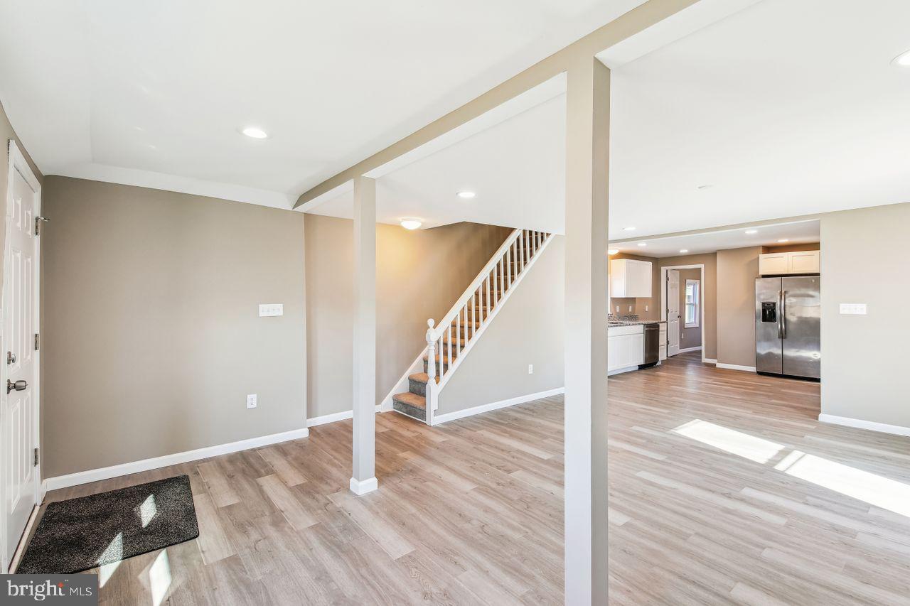 4912 Ocean Gateway Vienna, MD 21869 - Photo 6 of 35 a view of a hallway with wooden floor and staircase