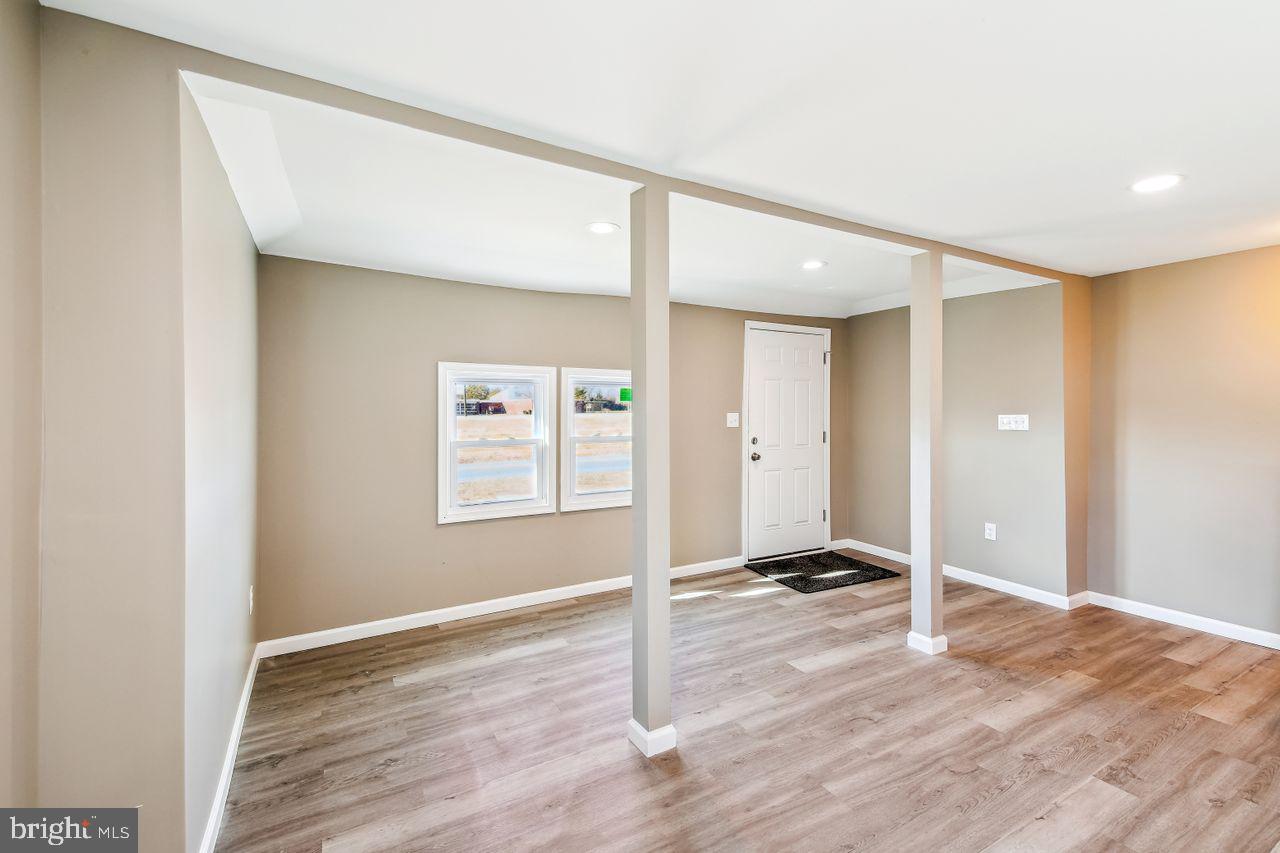 4912 Ocean Gateway Vienna, MD 21869 - Photo 7 of 35 a view of a room with wooden floor and a ceiling fan
