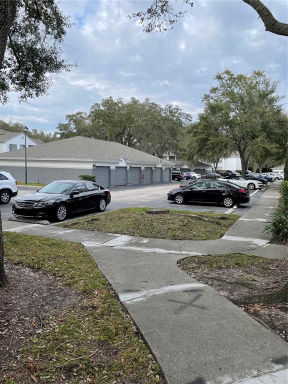 4356 South Kirkman Road, Unit 501 Orlando, FL 32811 - Photo 18 of 19 a view of yard with car parked