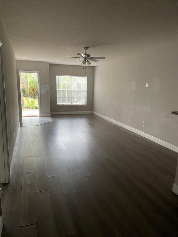4356 South Kirkman Road, Unit 501 Orlando, FL 32811 - Photo 6 of 19 an empty room with windows and ceiling fan