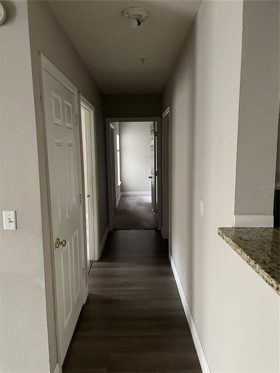 4356 South Kirkman Road, Unit 501 Orlando, FL 32811 - Photo 10 of 19 a view of a hallway with a wooden floor