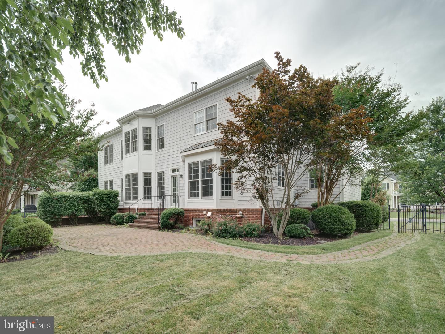 8429 Link Hills Loop Gainesville, VA 20155 - Photo 102 of 102 a front view of a house with a yard and trees