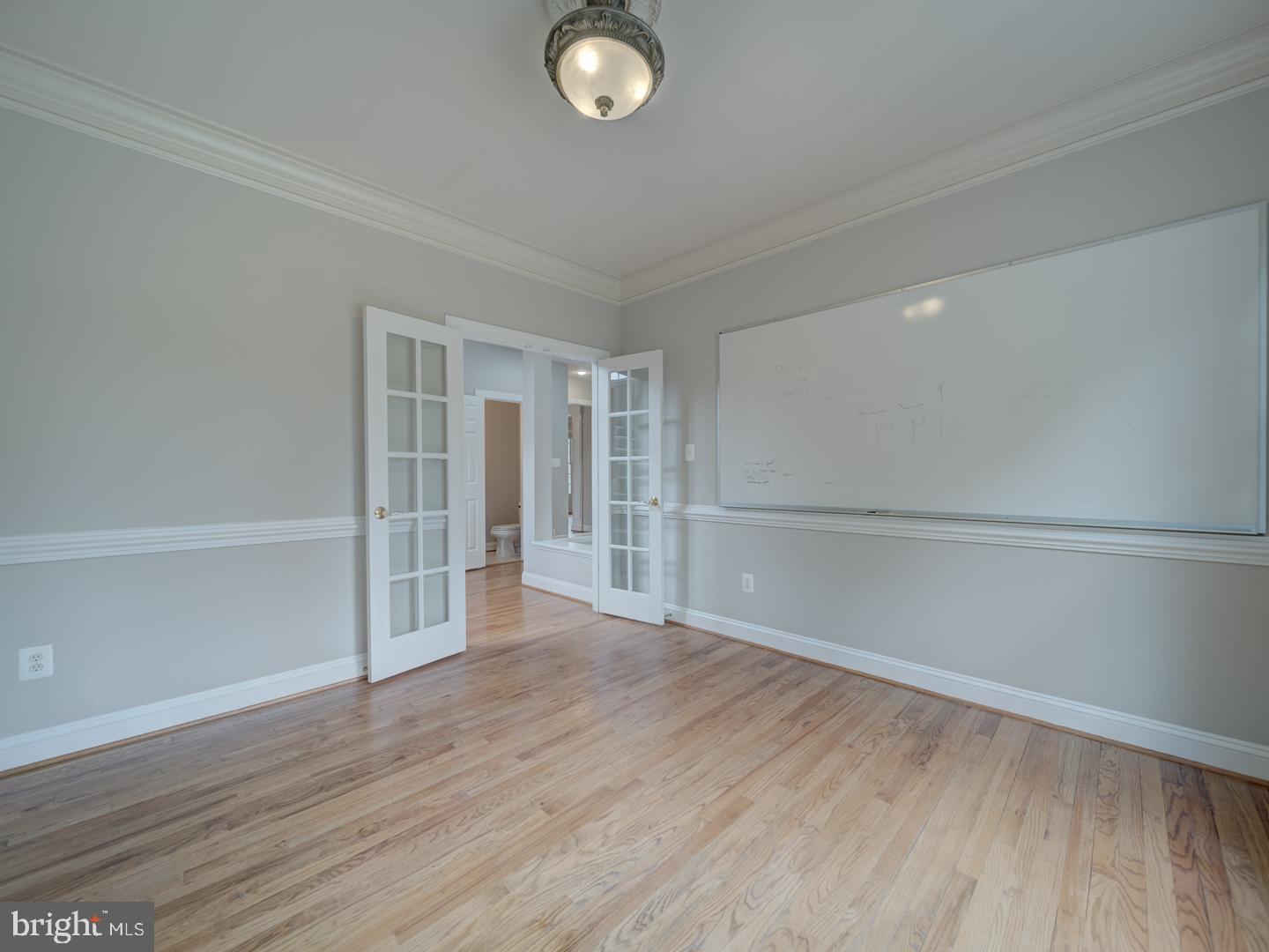 8429 Link Hills Loop Gainesville, VA 20155 - Photo 25 of 102 a view of an empty room with wooden floor and a window