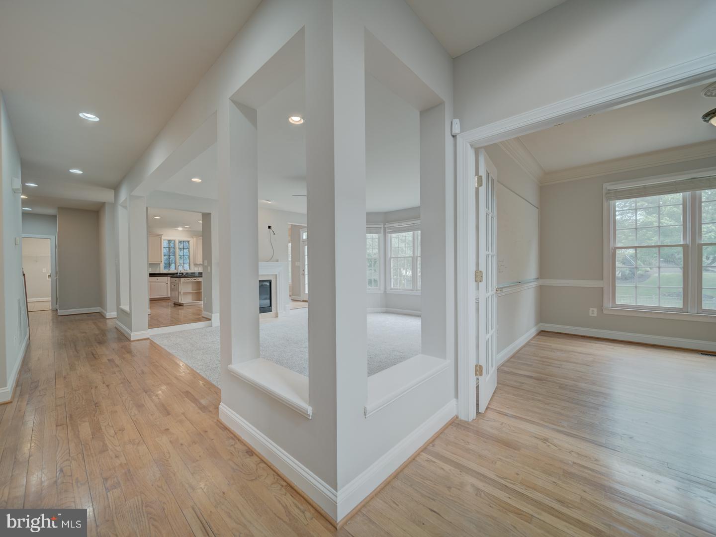 8429 Link Hills Loop Gainesville, VA 20155 - Photo 27 of 102 a view of a hallway with wooden floor and a living room