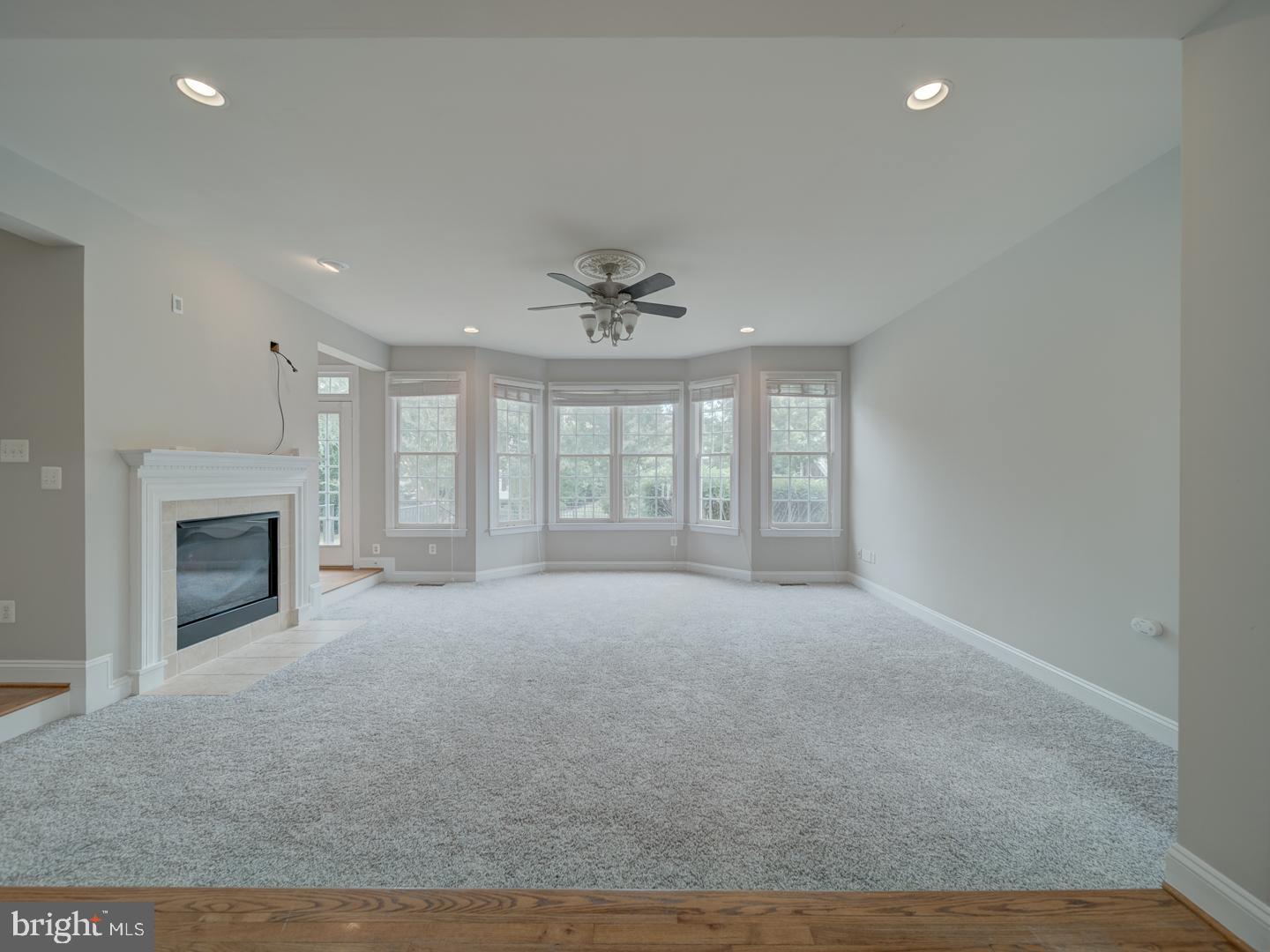 8429 Link Hills Loop Gainesville, VA 20155 - Photo 28 of 102 a view of an empty room with a fireplace and a window