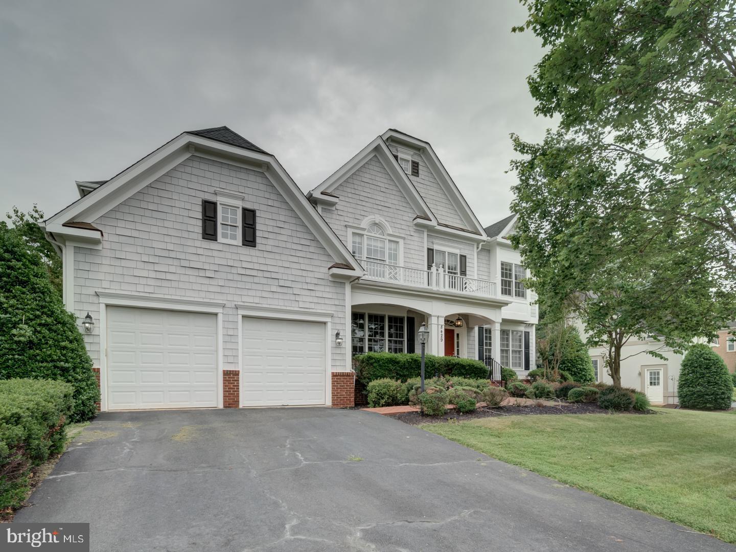 8429 Link Hills Loop Gainesville, VA 20155 - Photo 3 of 102 a front view of a house with a yard and garage