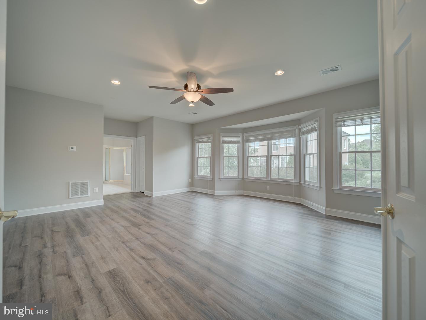 8429 Link Hills Loop Gainesville, VA 20155 - Photo 48 of 102 a view of an empty room with a window and wooden floor