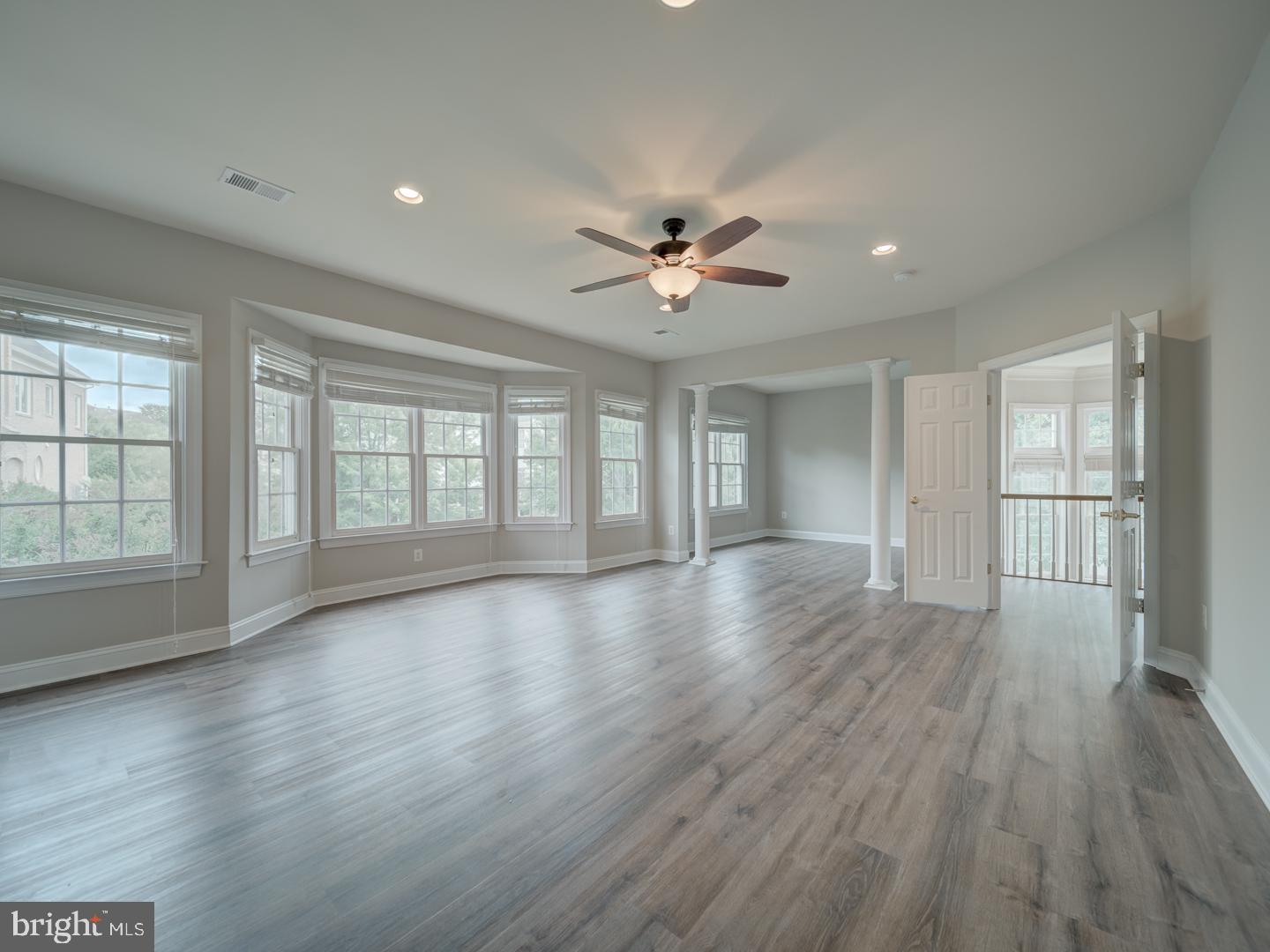 8429 Link Hills Loop Gainesville, VA 20155 - Photo 49 of 102 a view of an empty room with a window and wooden floor