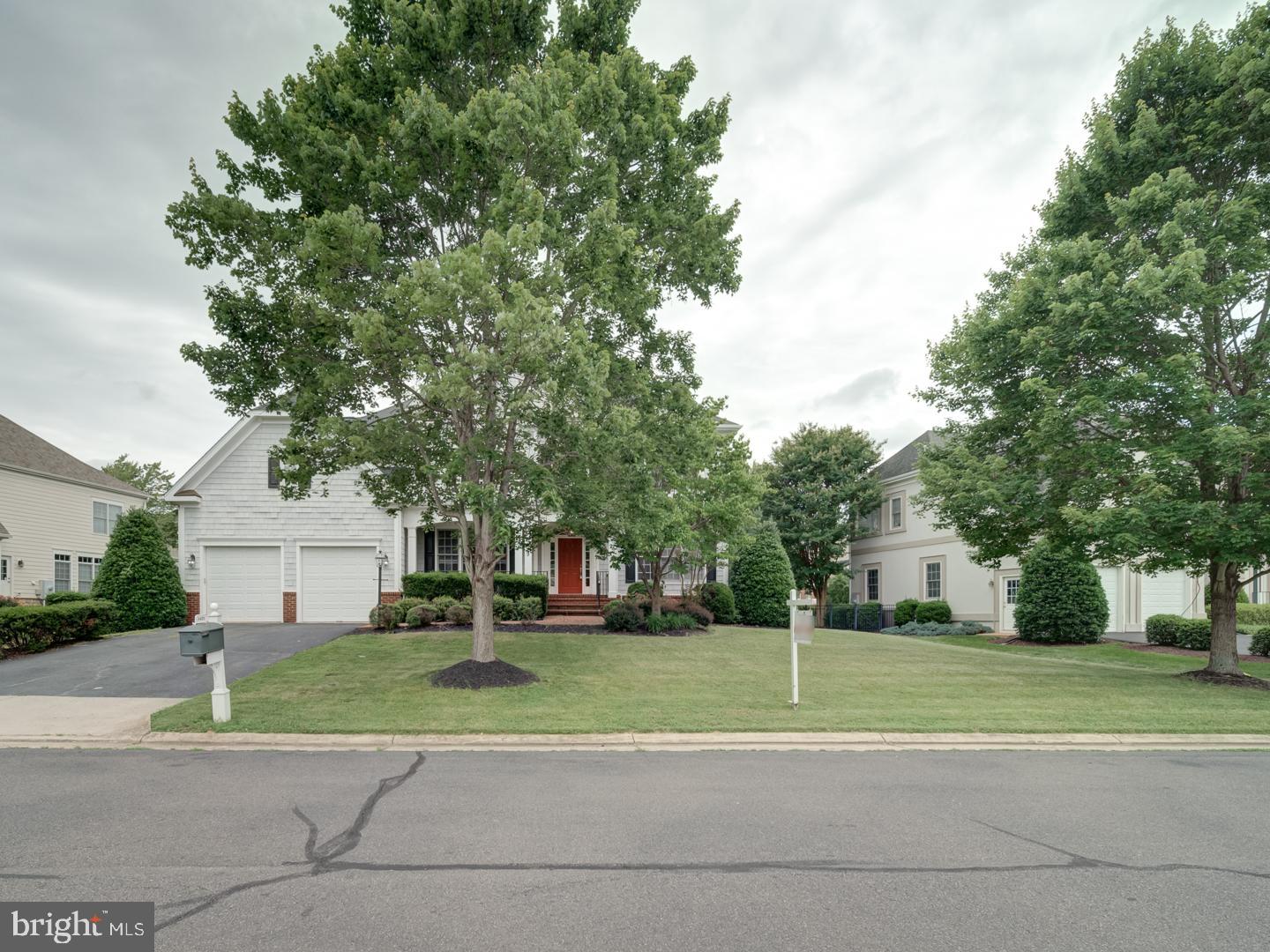 8429 Link Hills Loop Gainesville, VA 20155 - Photo 5 of 102 a view of a white house in a big yard with palm trees
