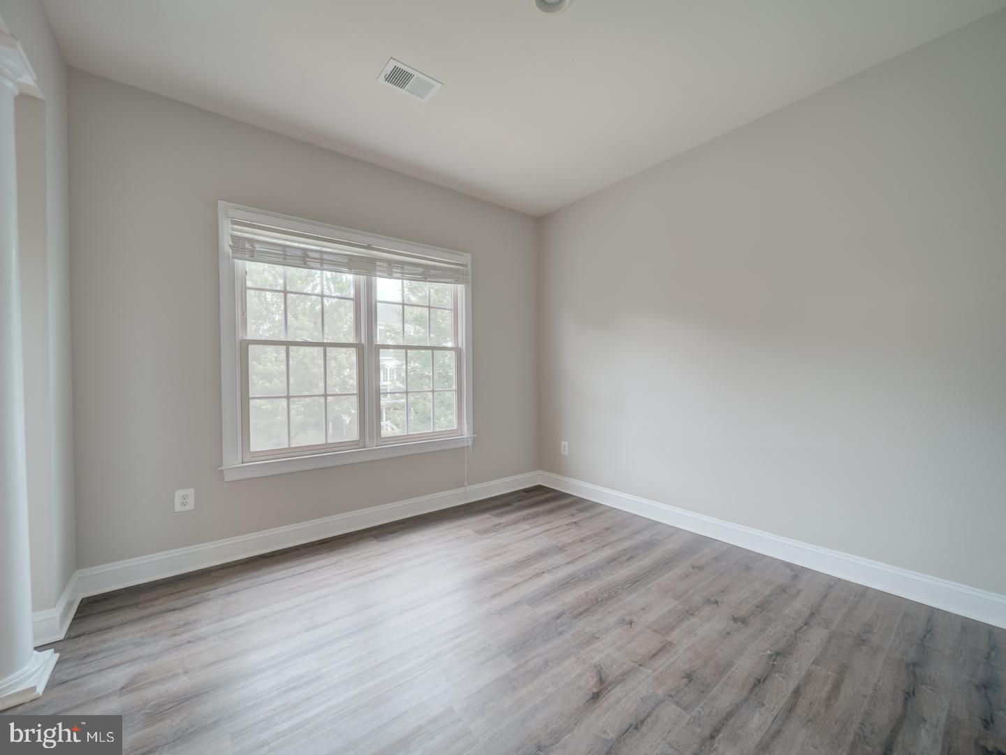 8429 Link Hills Loop Gainesville, VA 20155 - Photo 53 of 102 an empty room with wooden floor and windows