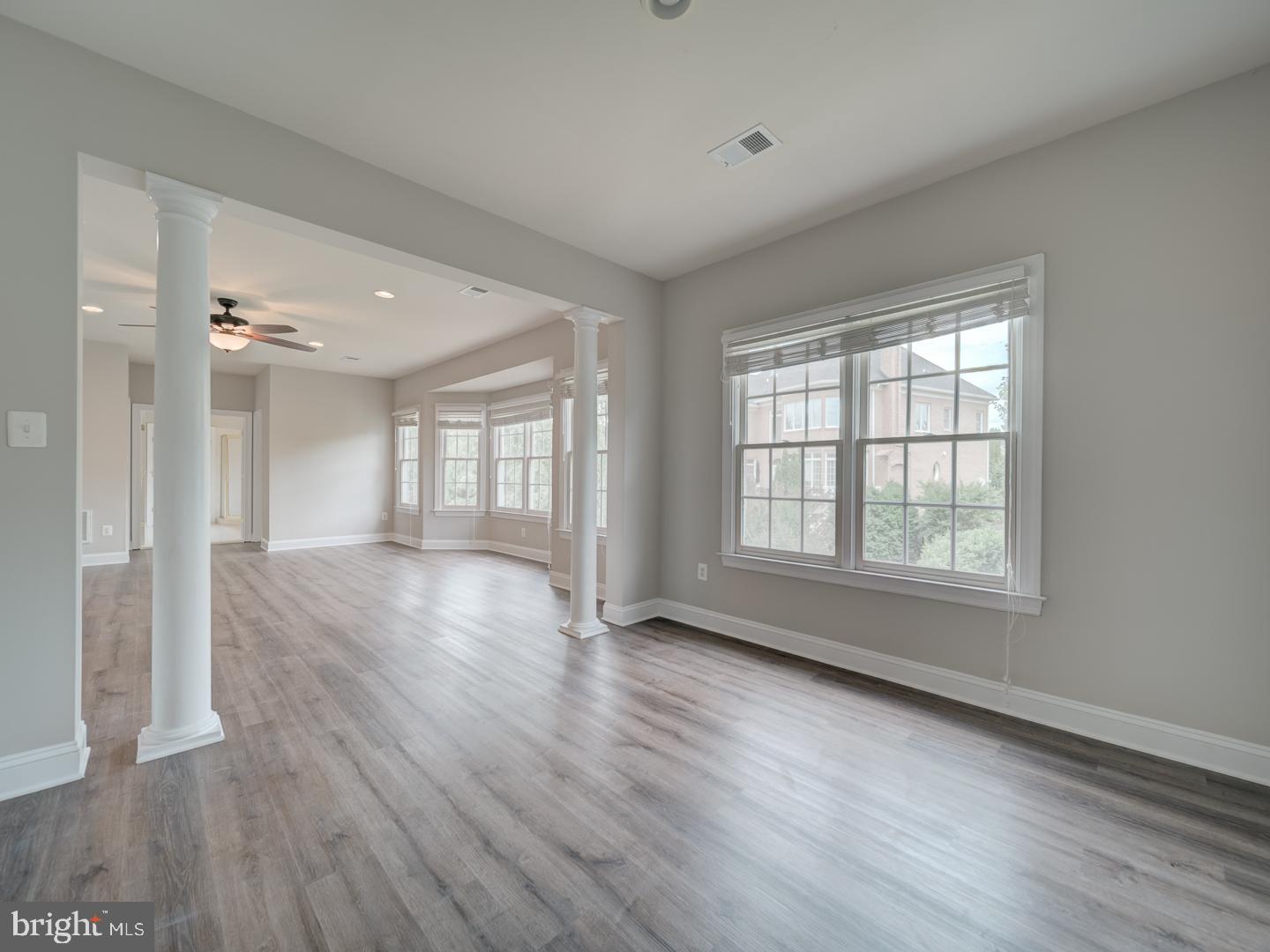 8429 Link Hills Loop Gainesville, VA 20155 - Photo 54 of 102 a view of an empty room with wooden floor and a window