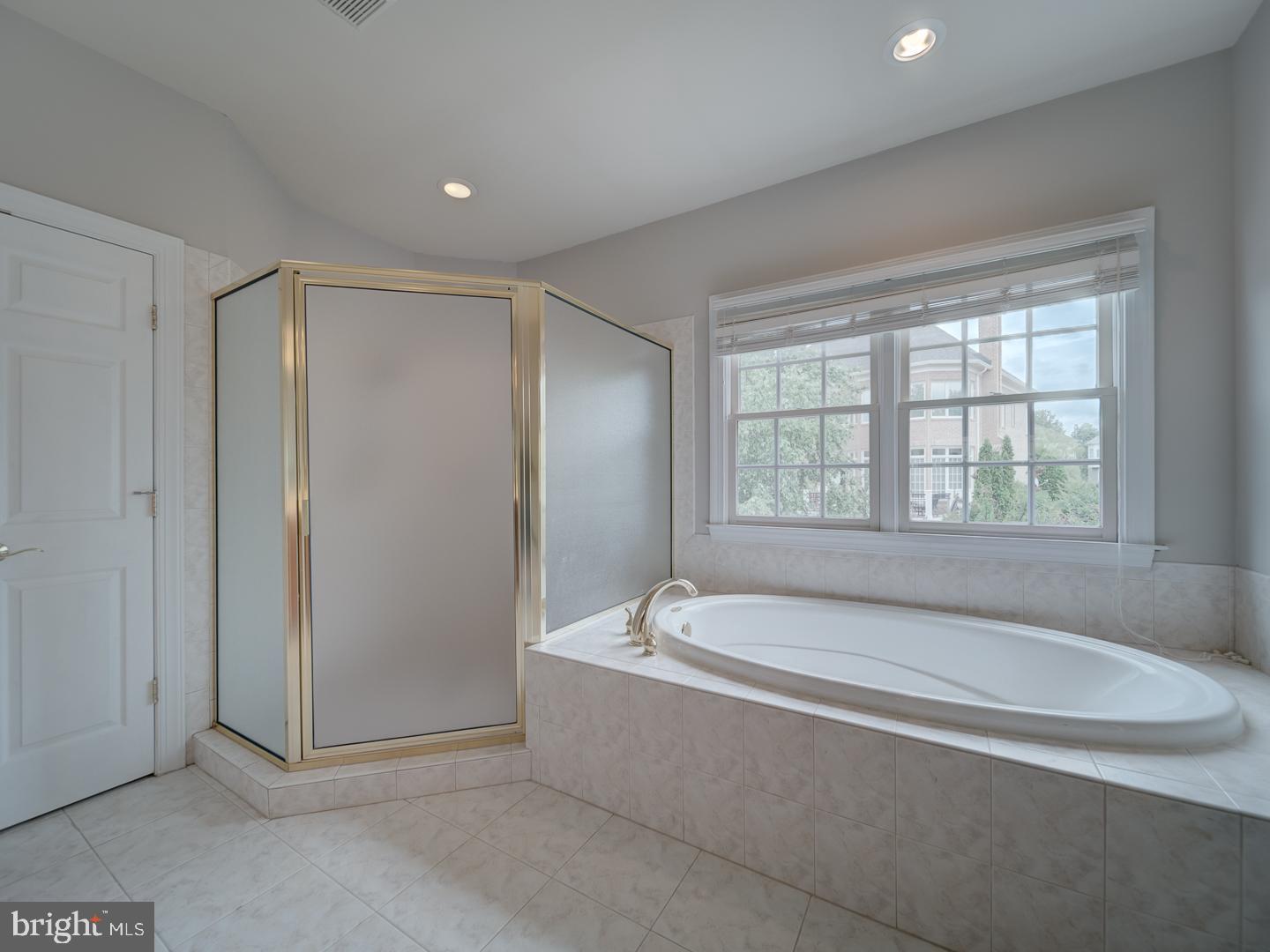 8429 Link Hills Loop Gainesville, VA 20155 - Photo 62 of 102 a spacious bathroom with bathtub and shower