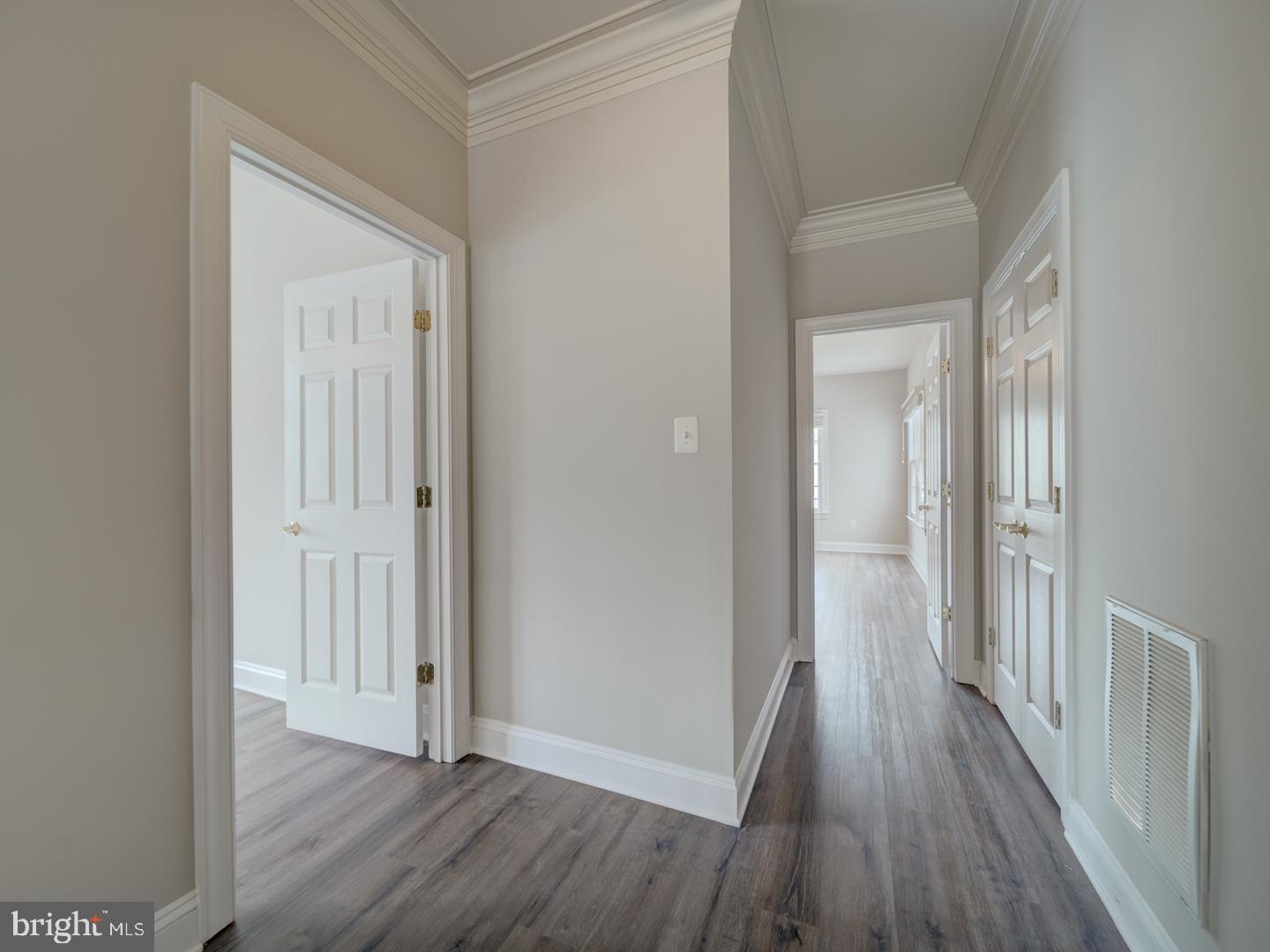 8429 Link Hills Loop Gainesville, VA 20155 - Photo 69 of 102 a view of a hallway with wooden floor