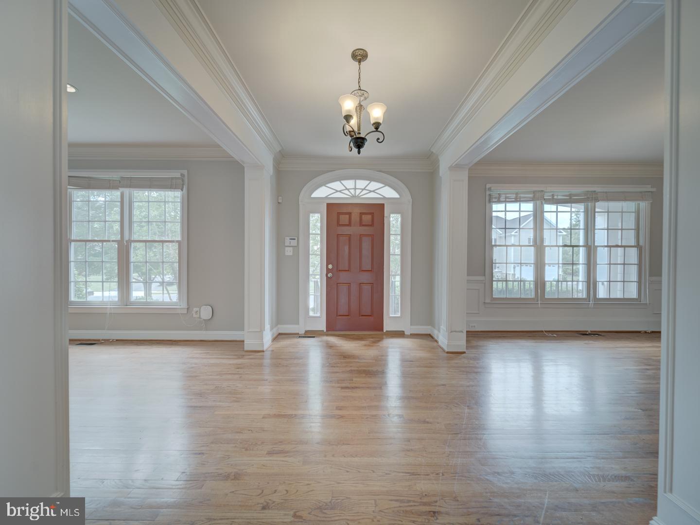 8429 Link Hills Loop Gainesville, VA 20155 - Photo 7 of 102 a view of an empty room with wooden floor and a window