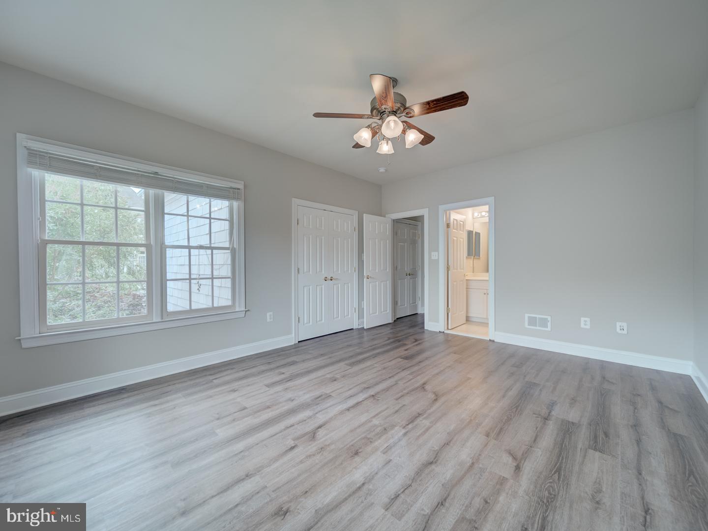 8429 Link Hills Loop Gainesville, VA 20155 - Photo 72 of 102 a view of an empty room with wooden floor and a window