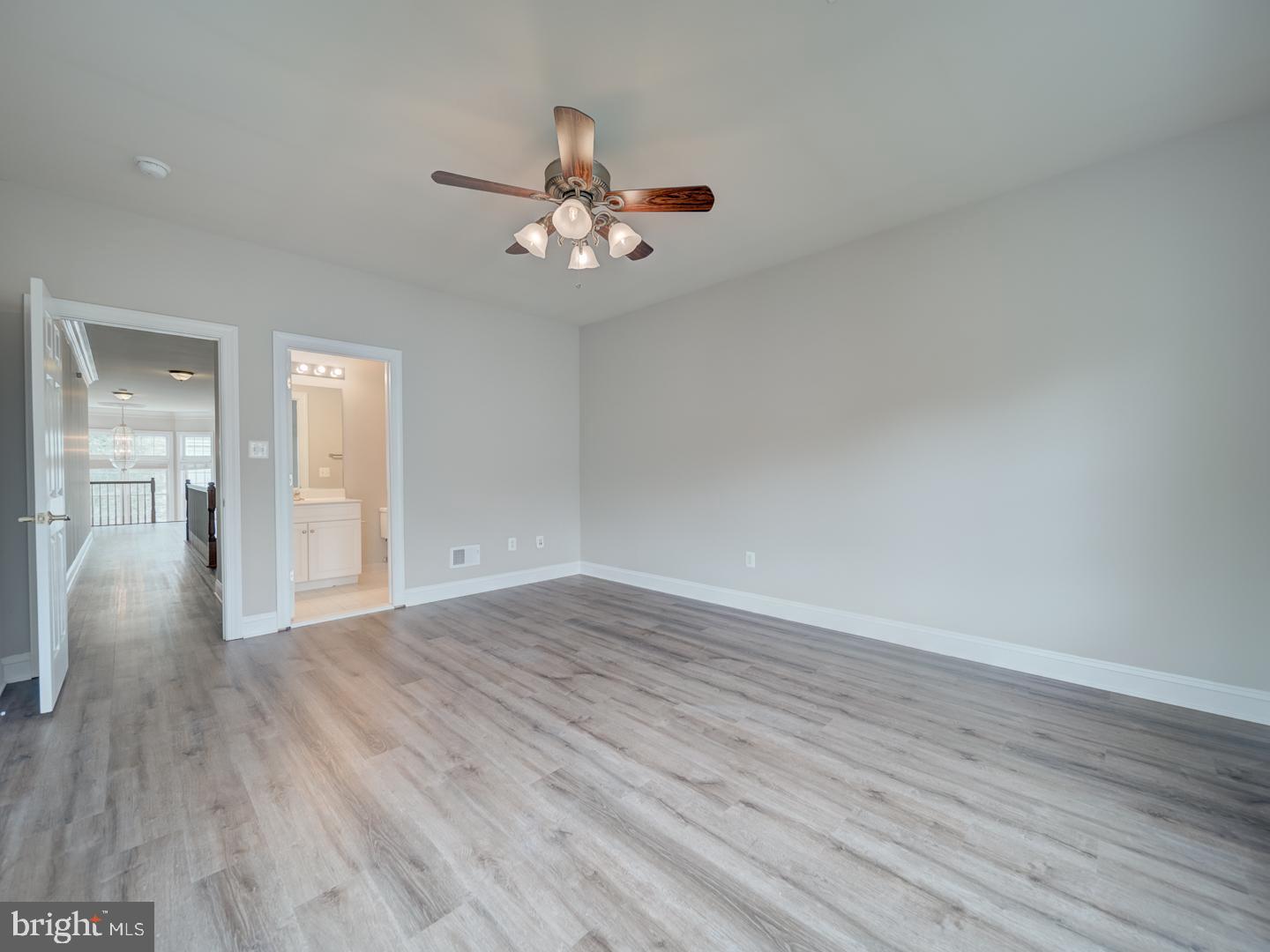 8429 Link Hills Loop Gainesville, VA 20155 - Photo 73 of 102 a view of an empty room with wooden floor