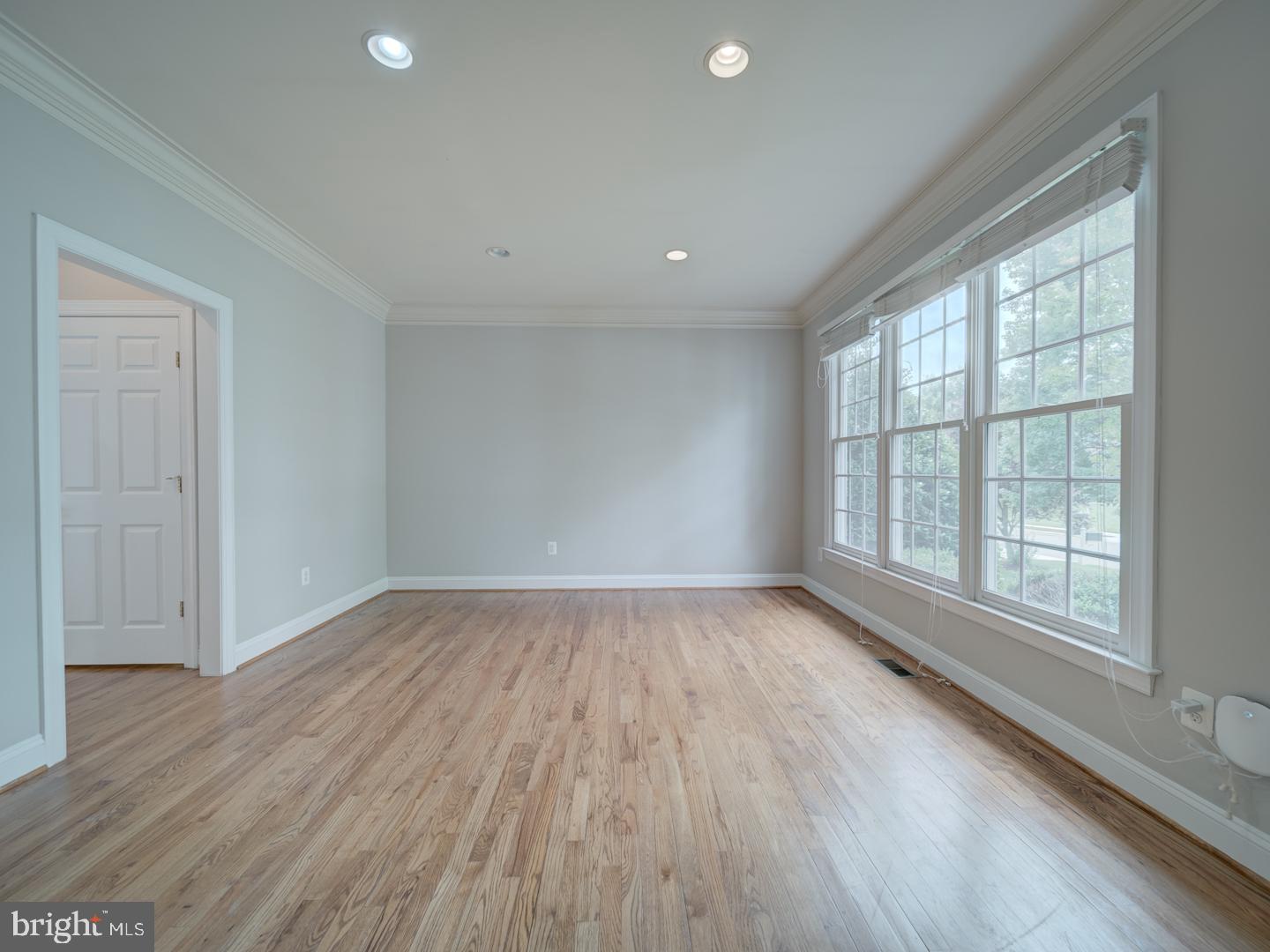 8429 Link Hills Loop Gainesville, VA 20155 - Photo 9 of 102 an empty room with wooden floor and windows