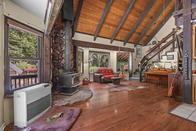 a living room with furniture a wooden floor and a flat screen tv
