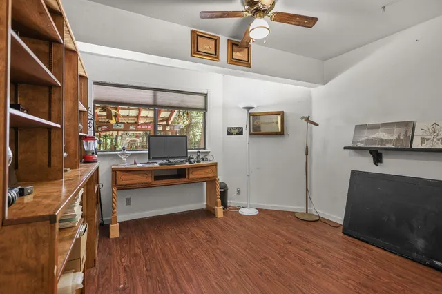 an empty room with wooden floor and closet