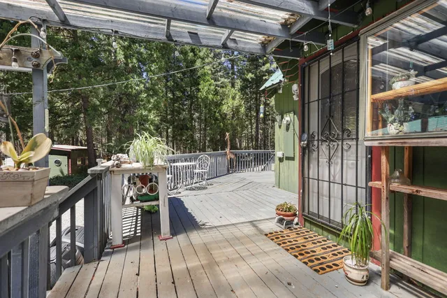 a patio with wooden fence and trees