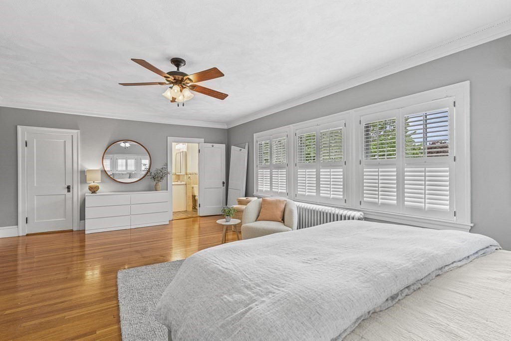 19 Edgehill Road Winchester, MA 01890 - Photo 28 of 42 a spacious bedroom with a bed a dresser and a chandelier