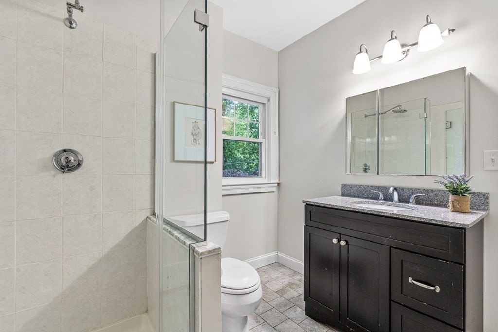 19 Edgehill Road Winchester, MA 01890 - Photo 33 of 42 a bathroom with a double vanity sink toilet and a mirror