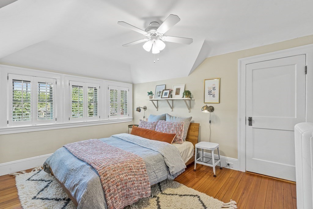 19 Edgehill Road Winchester, MA 01890 - Photo 38 of 42 a bedroom with a large bed and a chandelier