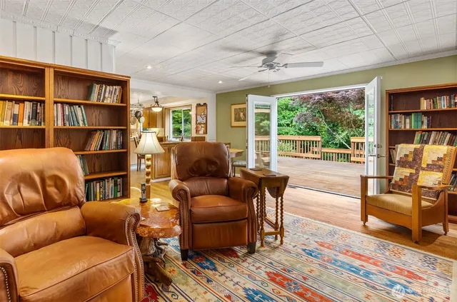 a living room with furniture and a book shelf
