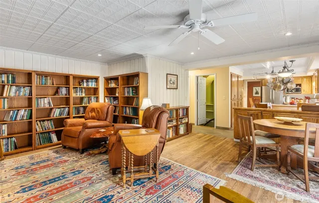 a living room with furniture and a book shelf