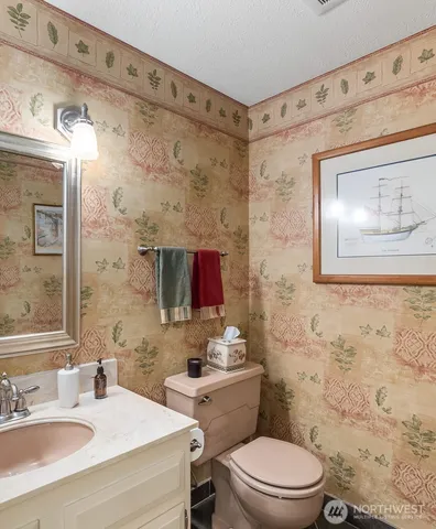 a bathroom with a toilet sink and mirror