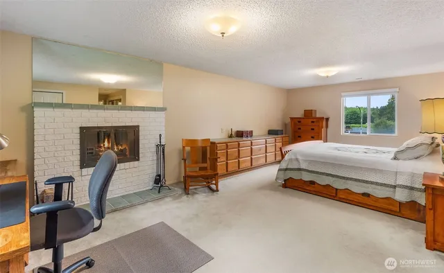 a bedroom with furniture and a fireplace