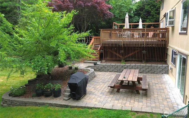 a view of a house with backyard sitting area and garden
