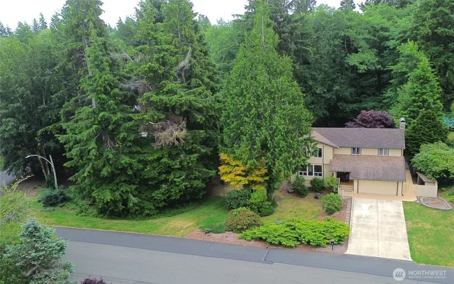 an aerial view of a house with garden space and street view