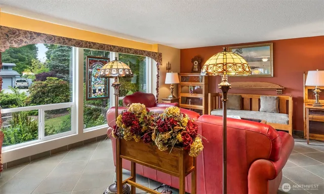a living room filled with furniture and a floor to ceiling window