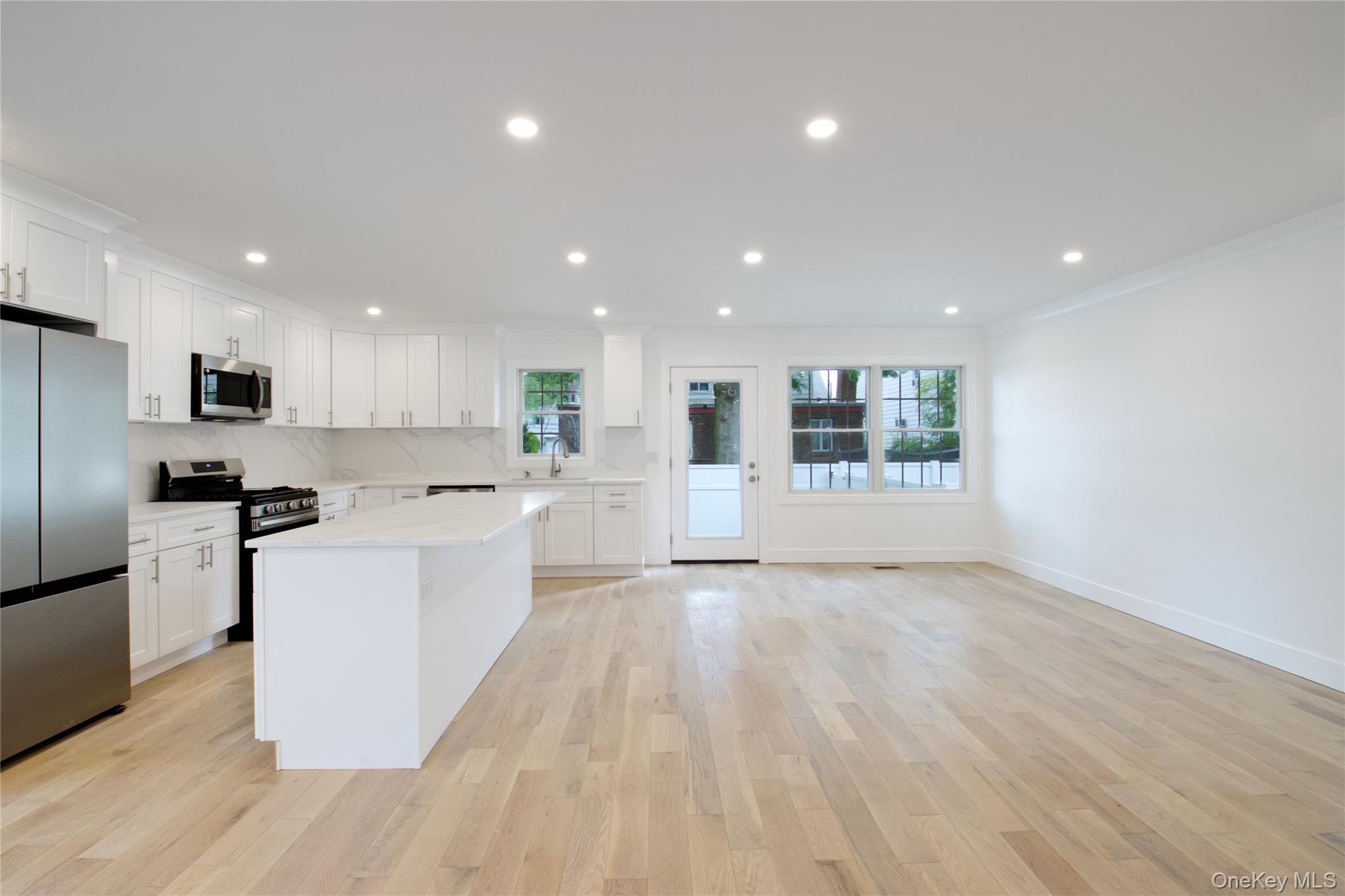30 Kirkwood Road, Unit B Port Washington, NY 11050 - Photo 7 of 36 a large kitchen with a lot of white cabinets a stainless steel appliances