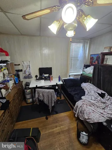 a bed sitting in a bedroom next to a window with tv