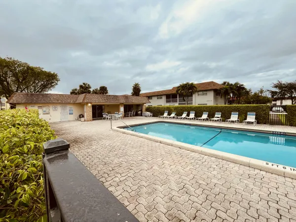 a view of a swimming pool with a yard