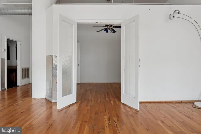 a view of a hallway with wooden floor