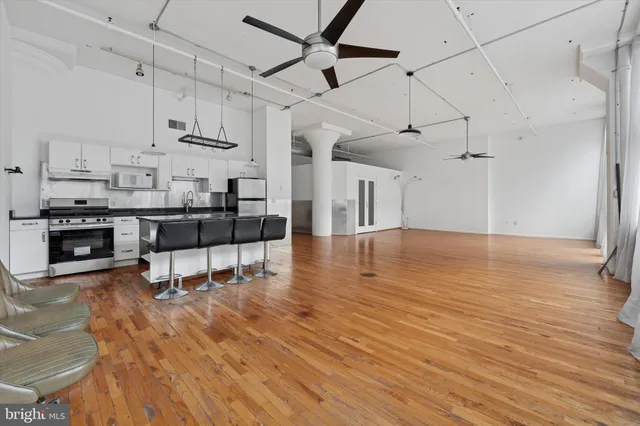 a living room with kitchen island granite countertop furniture and a fireplace