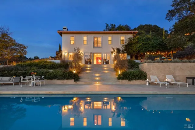 a view of a house with yard and lake view
