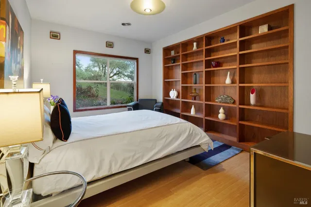 a bed sitting in a bedroom next to a window