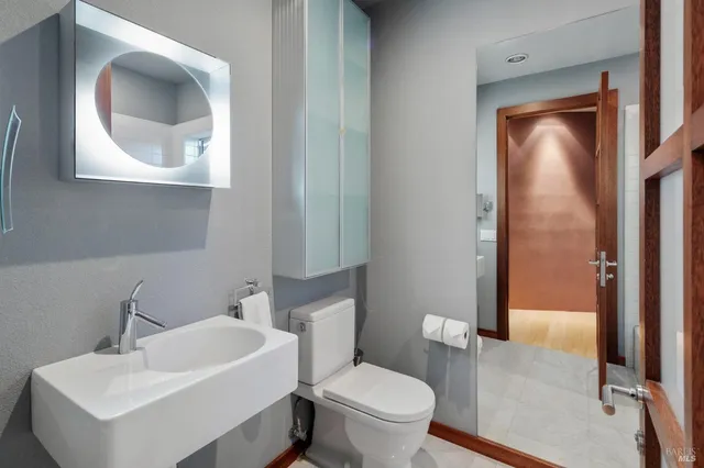 a bathroom with a toilet sink and mirror