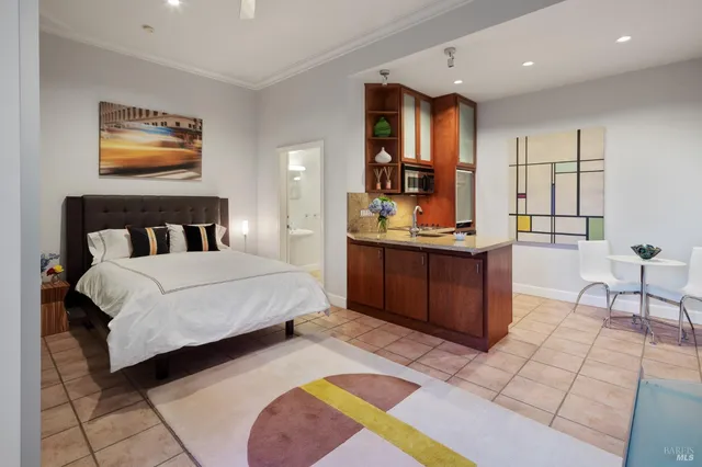 a bedroom with a bed and a view of kitchen