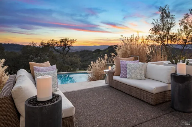 a balcony with furniture and a garden